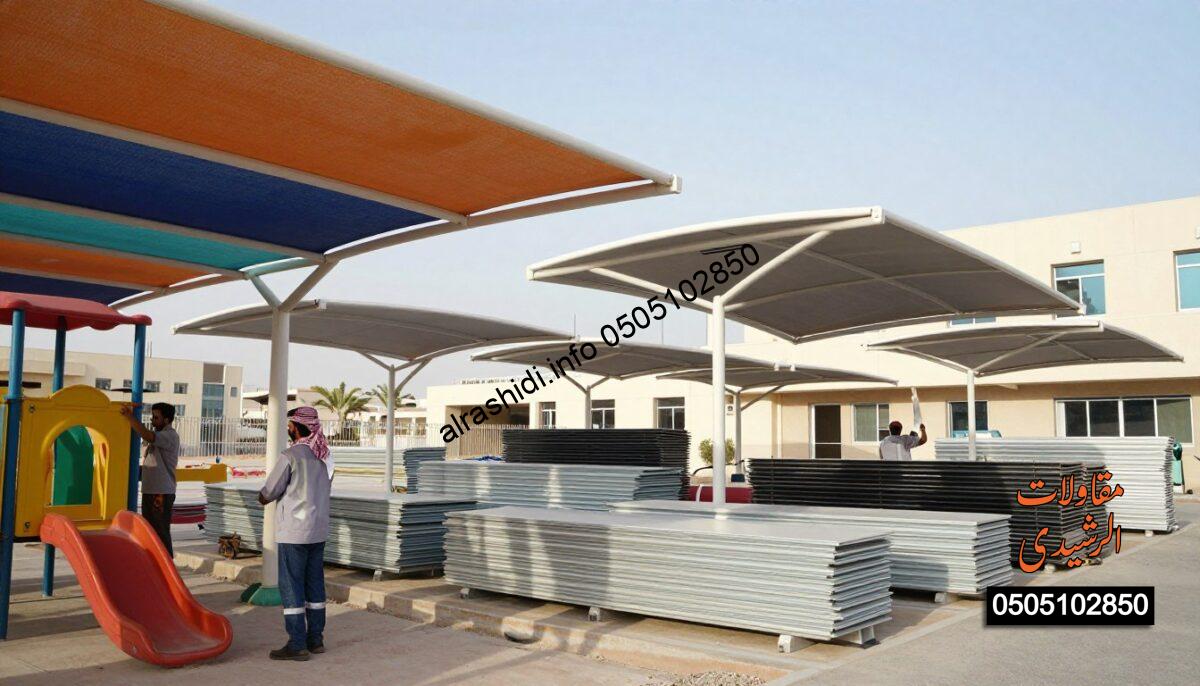A detailed and vibrant scene showcasing a construction site in Riyadh, Saudi Arabia, where workers in professional attire are installing various types of shades and canopies. In the foreground, a worker is carefully securing a large colorful shade over a school playground, while another is adjusting a sleek parking shade structure. The middle ground features neatly arranged stacks of materials, such as fabric and metal frames, reflecting the high quality associated with shade services. The background reveals a modern school building under the clear blue sky. Soft, natural lighting highlights the scene, creating an atmosphere of productivity and professionalism. The camera angle is slightly tilted upward to capture both the workers’ efforts and the extensive array of shades being installed, emphasizing the services offered by the company.