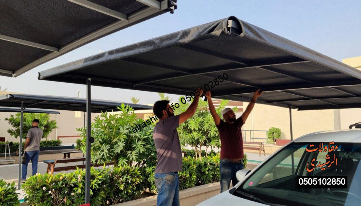 A realistic construction scene depicting skilled workers installing car shades in a North Riyadh setting. In the foreground, showcase two professional workers in modest casual attire, focused on assembling sturdy car canopies. Highlight the textures and colors of the materials used, emphasizing the functionality of the shades. In the middle ground, include partially constructed garden and school shades, with green foliage and some outdoor benches visible. The background should feature a clear blue sky and a hint of local architecture, creating an inviting atmosphere. Use soft, natural lighting to highlight the scene, capturing a sense of productivity and professionalism. The camera angle should be slightly elevated, offering a comprehensive view of the busy work site while maintaining clarity and detail.
