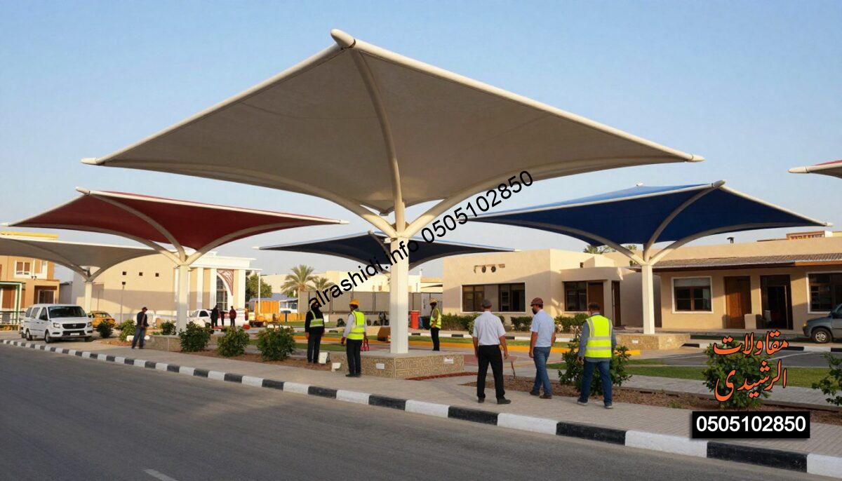 A realistic construction scene showcasing the advantages of Laksan canopies in East Riyadh. In the foreground, skilled workers in professional business attire are installing large, modern Laksan canopies over various areas such as a parking lot, schoolyard, and garden, demonstrating their versatility. The middle ground features sleek, architecturally interesting Laksan canopies in vibrant colors, casting soft shadows on the ground below. In the background, traditional Saudi architectural elements blend seamlessly with contemporary design, under a clear blue sky drenched in warm sunlight. Capture the sense of innovation and functionality, emphasizing the durability and practical benefits of these structures. Use a wide-angle lens perspective to encapsulate the full environment, highlighting the busy and productive atmosphere of the construction site. A realistic construction scene showcasing the advantages of Laksan canopies in East Riyadh. In the foreground, skilled workers in professional business attire are installing large, modern Laksan canopies over various areas such as a parking lot, schoolyard, and garden, demonstrating their versatility. The middle ground features sleek, architecturally interesting Laksan canopies in vibrant colors, casting soft shadows on the ground below. In the background, traditional Saudi architectural elements blend seamlessly with contemporary design, under a clear blue sky drenched in warm sunlight. Capture the sense of innovation and functionality, emphasizing the durability and practical benefits of these structures. Use a wide-angle lens perspective to encapsulate the full environment, highlighting the busy and productive atmosphere of the construction site.