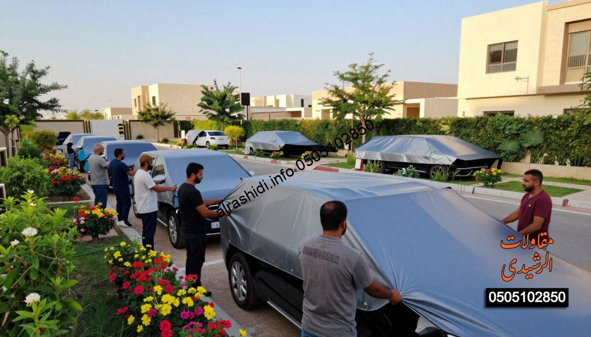 A realistic construction scene showcasing workers professionally installing car shades in a residential area of northern Riyadh. In the foreground, a diverse team of five workers in modest, professional attire focuses on positioning a large, stylish car shade structure over a parked vehicle. In the middle-ground, various shades are being erected, illustrating different designs suitable for gardens and parking areas, surrounded by lush greenery and vibrantly colored flowers. The background features a clear blue sky and a modern residential building that enhances the context. Soft, warm lighting captures the scene, creating an inviting atmosphere that conveys customer satisfaction and quality workmanship. The perspective should be slightly elevated, providing a full view of the installation process without any text or overlays.