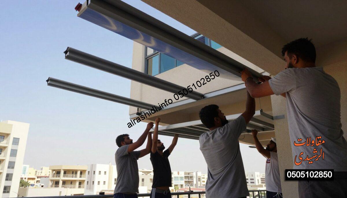 A realistic scene depicting workers professionally installing balcony shades in a construction setting in Saudi Arabia. In the foreground, a group of workers in modest casual clothing is carefully assembling metal structures for the shades. The middle layer presents the partially completed balcony shades, showcasing their sleek design with vibrant colors against the clear blue sky. The background features a typical urban Saudi landscape with other buildings, emphasizing the context of a bustling construction site. Soft, natural lighting enhances the scene, creating a bright and productive atmosphere. The angle captures the action from slightly below, giving a dynamic perspective that brings attention to the hardworking individuals and their craftsmanship.