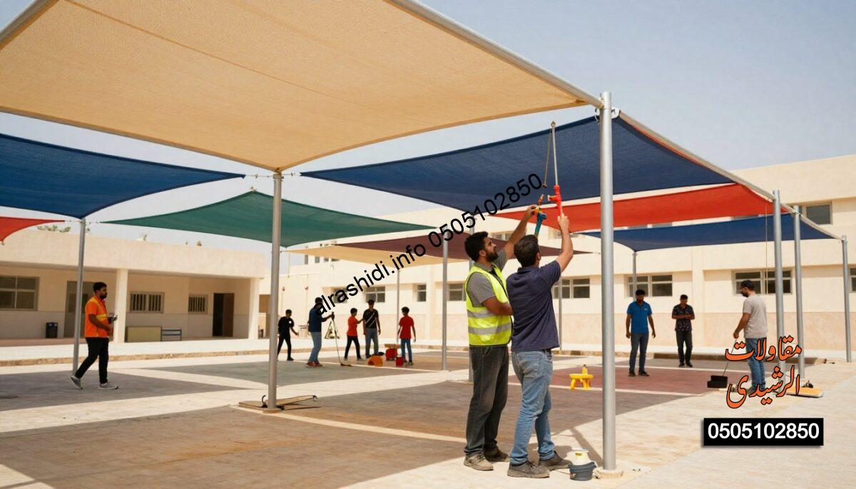 Workers in professional attire diligently installing large, colorful school shade structures in a sunny outdoor setting in West Riyadh. In the foreground, a skilled team uses tools and equipment, focusing on the precision of their work. The middle ground features several vibrant and sturdy shades providing protection from the sun for nearby schoolchildren playing. The background showcases a school building with clear blue skies overhead. Soft, natural lighting highlights the scene, creating a warm and inviting atmosphere. The image captures a sense of teamwork and dedication to quality and safety in shade installation, reflecting the importance of shade protection in school environments.
